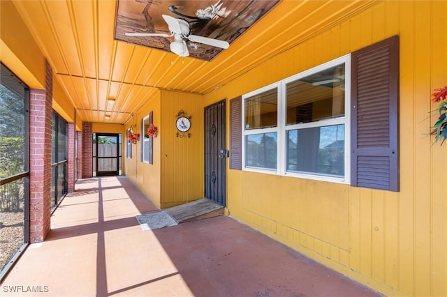 view of exterior entry with ceiling fan