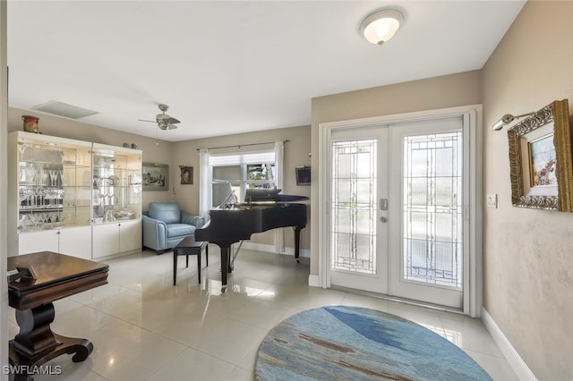 foyer featuring ceiling fan, baseboards, light tile patterned floors, and french doors