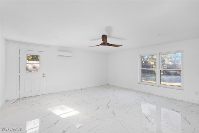 spare room with ceiling fan and a wall mounted AC