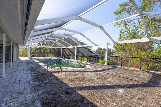 view of swimming pool featuring a lanai and a patio