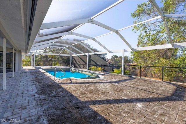 view of pool featuring a patio area and glass enclosure