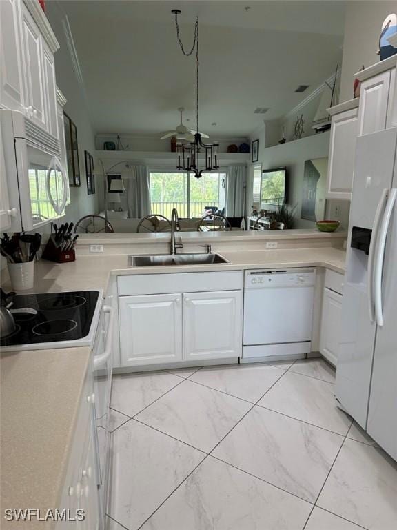 kitchen featuring white appliances, white cabinetry, sink, and kitchen peninsula