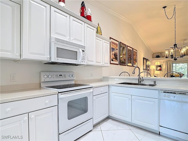 kitchen with ornamental molding, white appliances, light countertops, and a sink