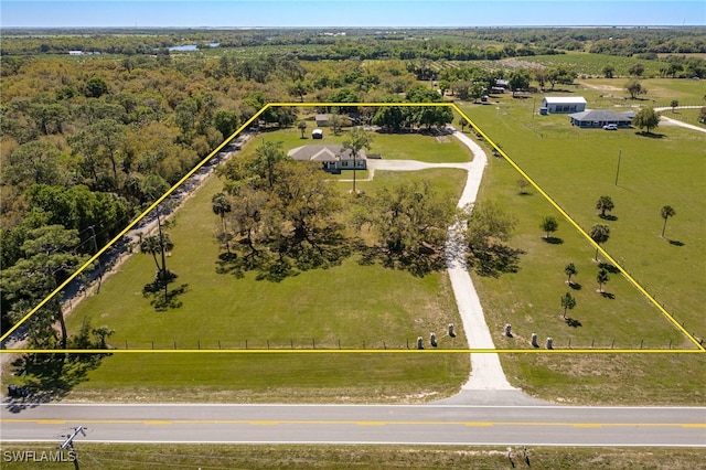 drone / aerial view featuring a wooded view