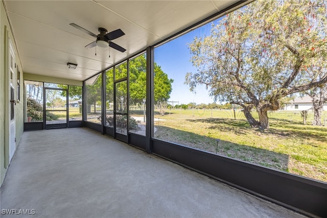 unfurnished sunroom with a ceiling fan