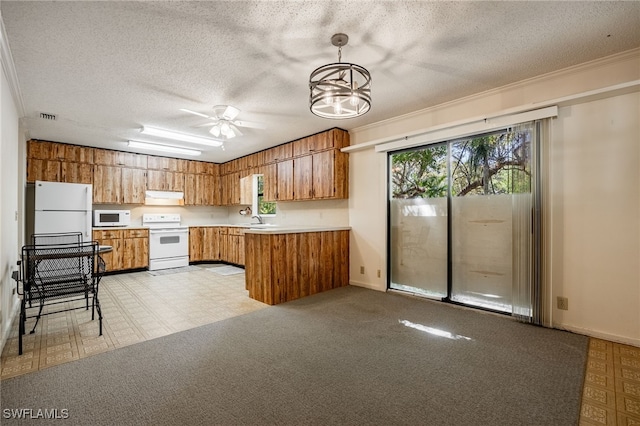 kitchen with ventilation hood, a peninsula, brown cabinetry, white appliances, and a sink