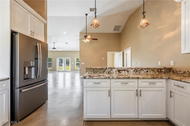 kitchen featuring visible vents, concrete floors, a peninsula, stainless steel fridge with ice dispenser, and white cabinets