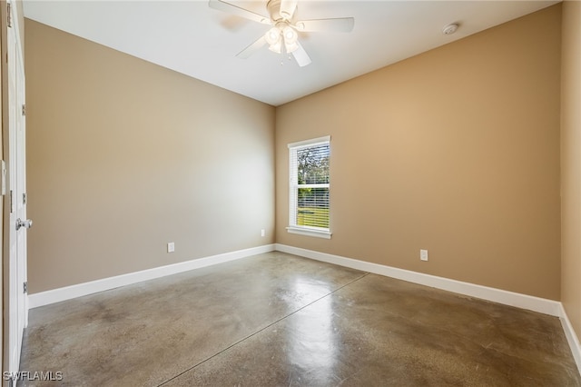 unfurnished room featuring ceiling fan, baseboards, and finished concrete floors