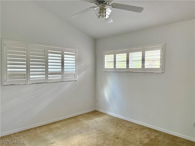 unfurnished room featuring lofted ceiling, light carpet, and ceiling fan