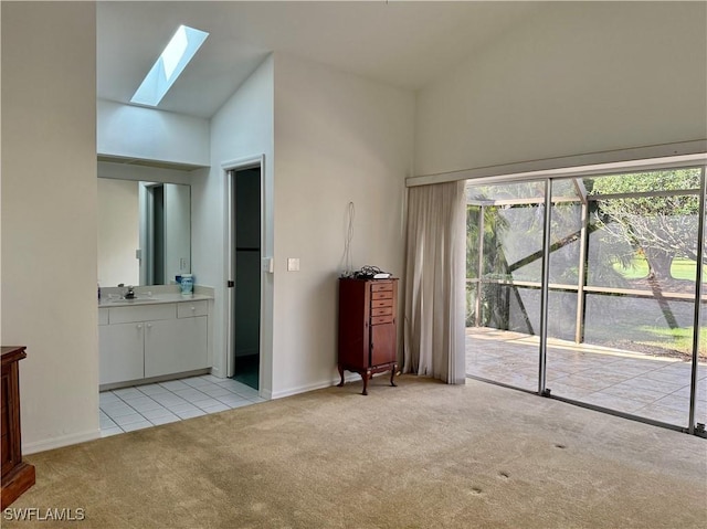 unfurnished living room featuring light colored carpet, high vaulted ceiling, and a wealth of natural light