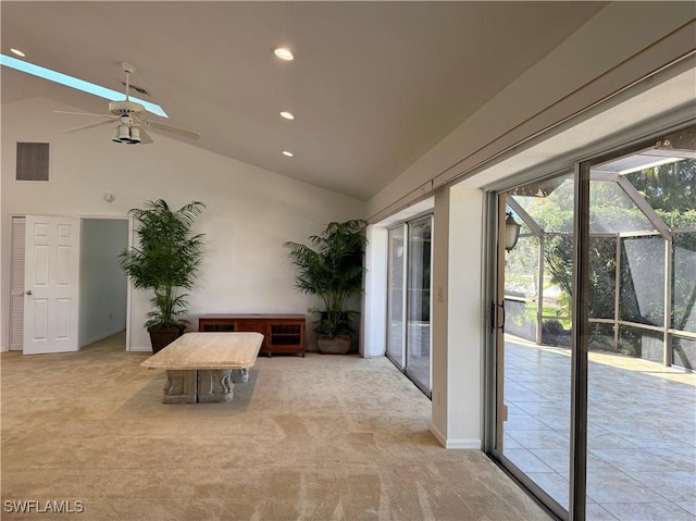 interior space with light carpet, high vaulted ceiling, and ceiling fan