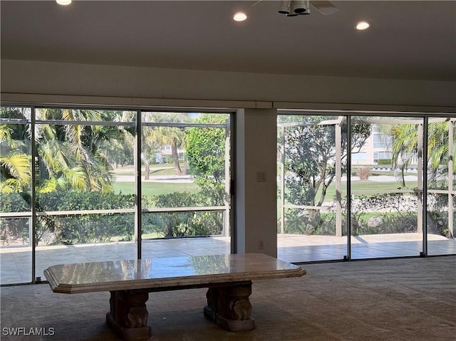 doorway to outside featuring carpet floors