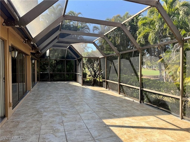 unfurnished sunroom featuring lofted ceiling