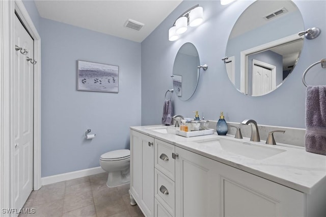 bathroom featuring tile patterned floors, vanity, and toilet