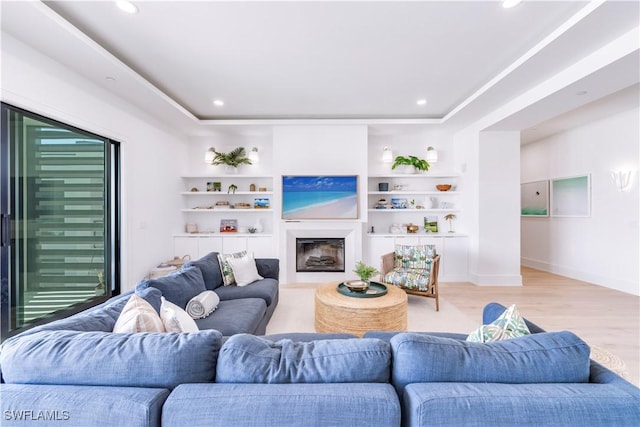 living room featuring built in features and light wood-type flooring