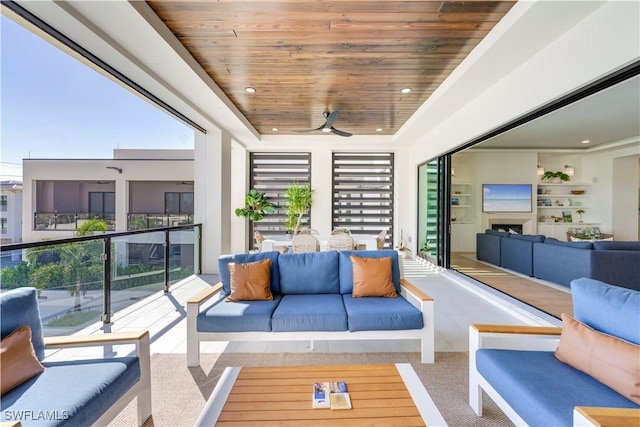 interior space with an outdoor hangout area and ceiling fan