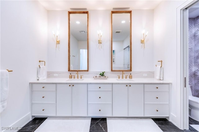 bathroom featuring vanity and toilet