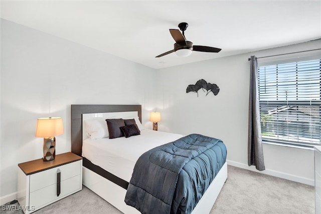 bedroom with ceiling fan and light carpet