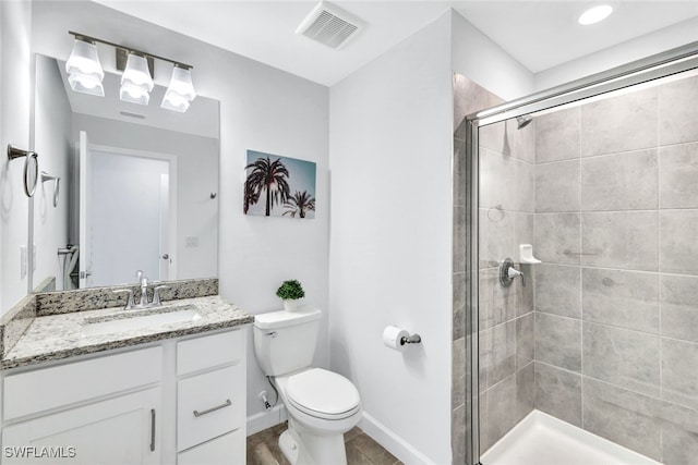 bathroom featuring vanity, toilet, and an enclosed shower