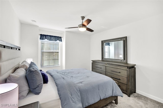 bedroom featuring light carpet and ceiling fan