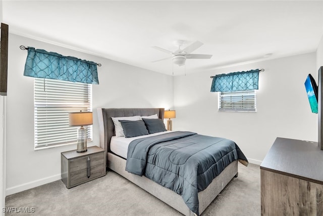 carpeted bedroom with multiple windows and ceiling fan