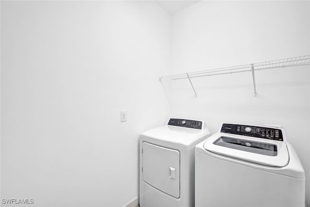 washroom featuring washing machine and dryer