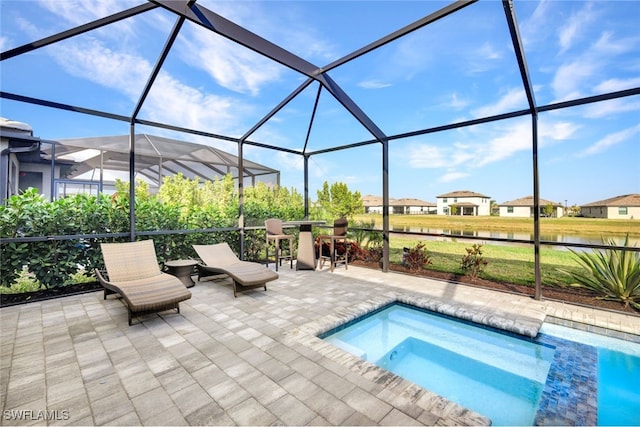 view of swimming pool with a jacuzzi, a patio area, and glass enclosure