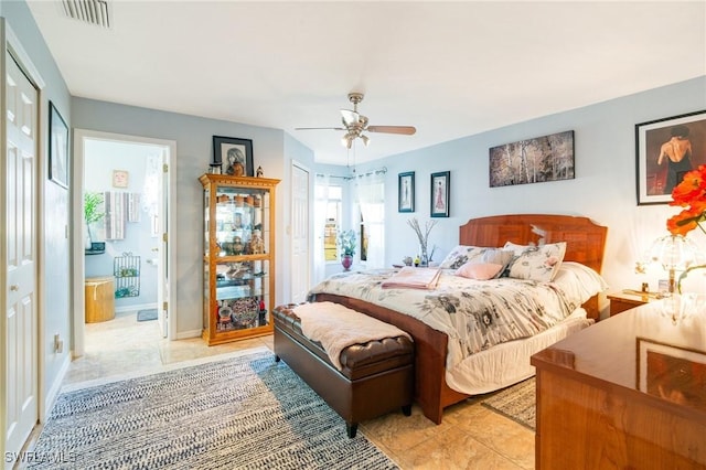 tiled bedroom featuring ceiling fan and connected bathroom