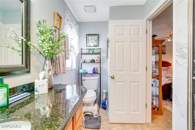 bathroom featuring vanity, tile patterned floors, ceiling fan, and toilet