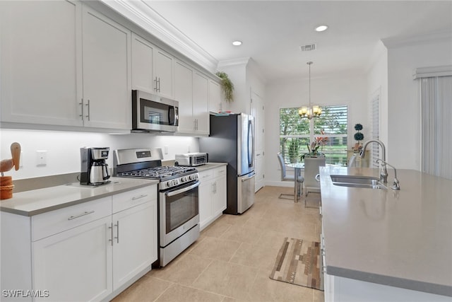 kitchen with sink, crown molding, decorative light fixtures, stainless steel appliances, and white cabinets