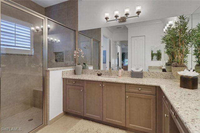 bathroom with tile patterned flooring, vanity, crown molding, and walk in shower