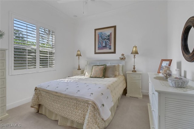 carpeted bedroom with crown molding and ceiling fan