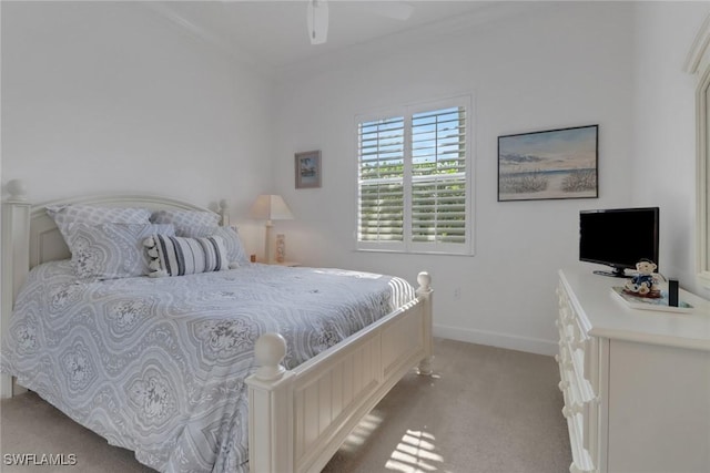 bedroom with ornamental molding, light colored carpet, and ceiling fan