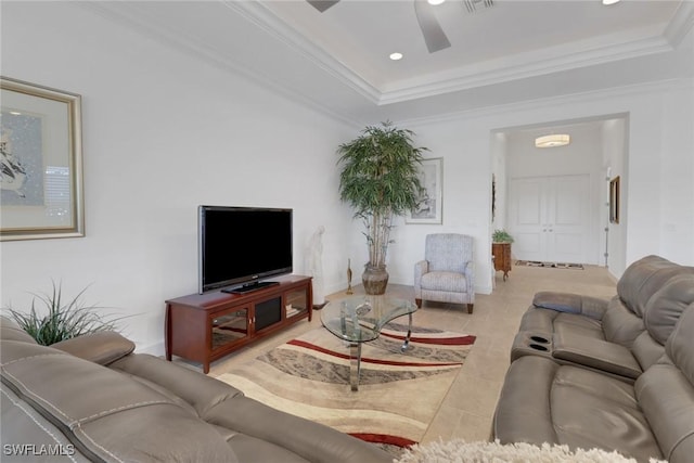 tiled living room with crown molding, ceiling fan, and a tray ceiling