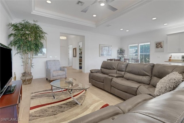 living room with crown molding, ceiling fan, and a raised ceiling