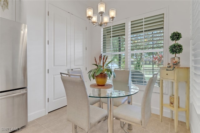 tiled dining room with a chandelier