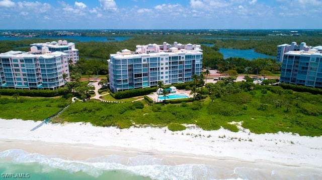 drone / aerial view with a water view and a view of the beach