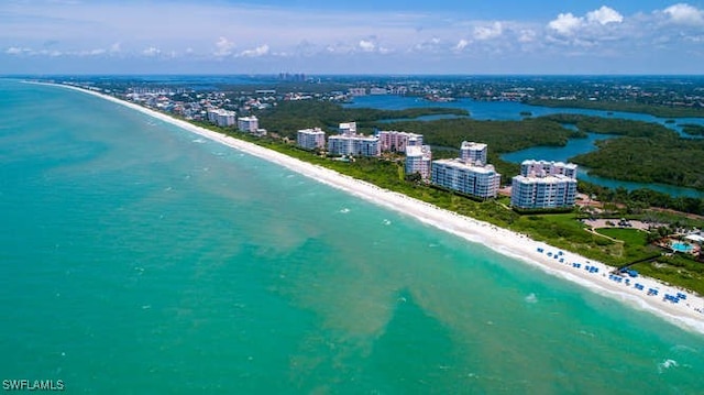 drone / aerial view featuring a view of the beach and a water view