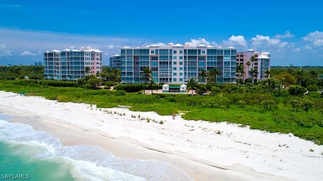 view of property featuring a view of the beach and a water view