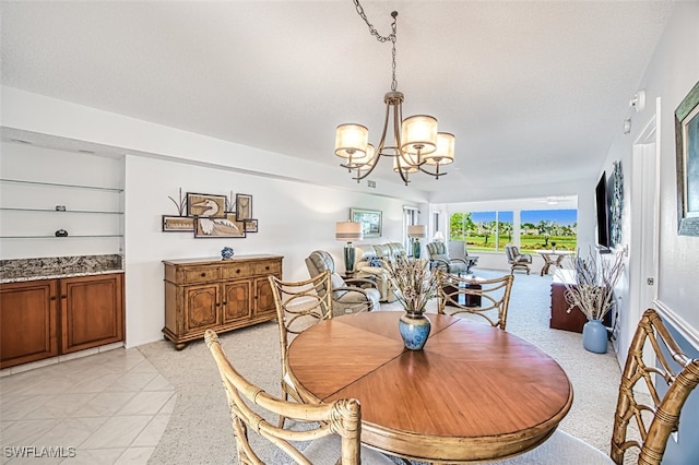 dining area with a chandelier and a textured ceiling