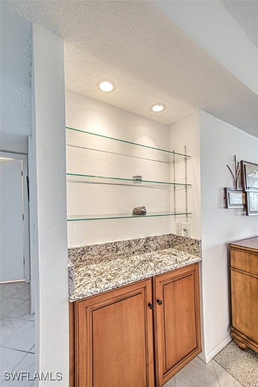 bathroom with vanity and a textured ceiling