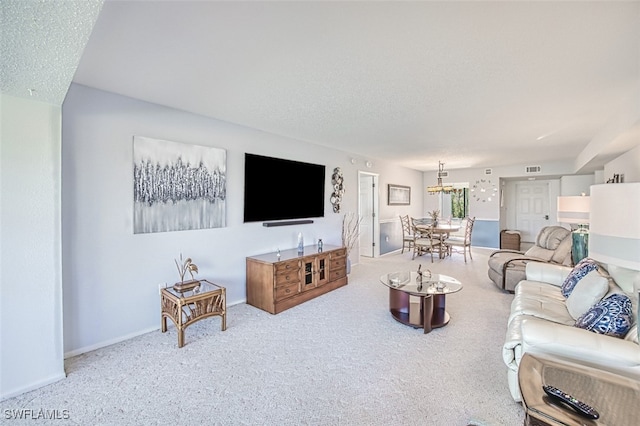 carpeted living room featuring a textured ceiling