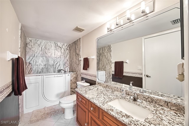 bathroom with vanity, a washtub, tile patterned floors, and toilet