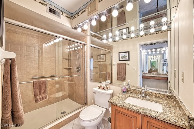 bathroom featuring an enclosed shower, vanity, and toilet