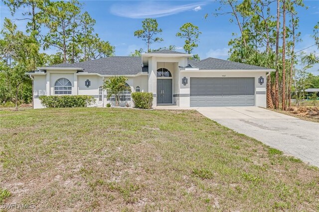 ranch-style home with a garage and a front lawn