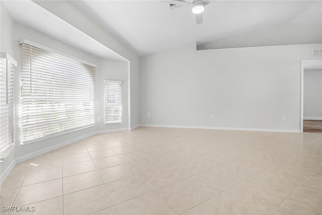 tiled spare room with lofted ceiling and ceiling fan