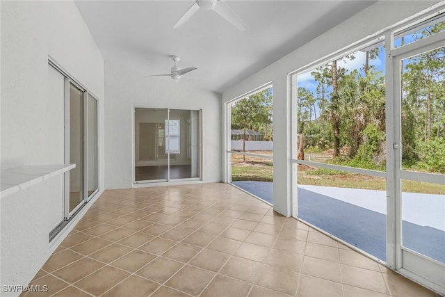 unfurnished sunroom featuring ceiling fan