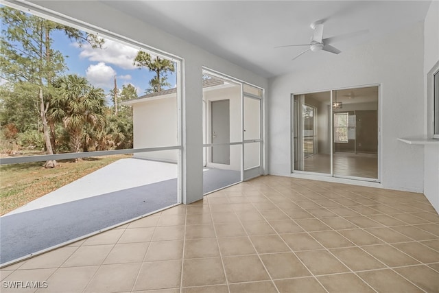 unfurnished sunroom featuring vaulted ceiling and ceiling fan