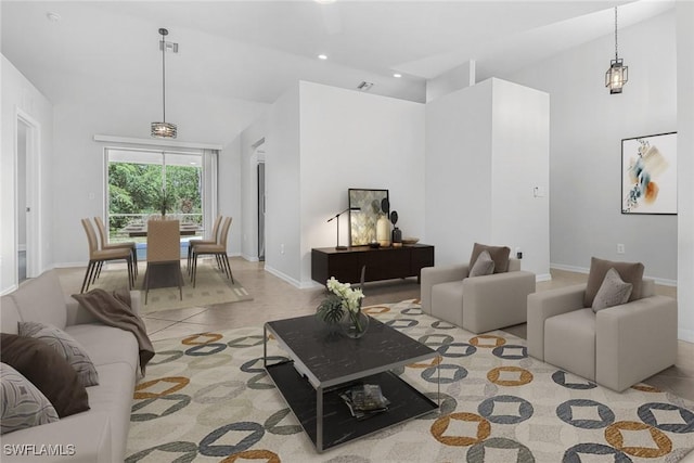 tiled living room with high vaulted ceiling