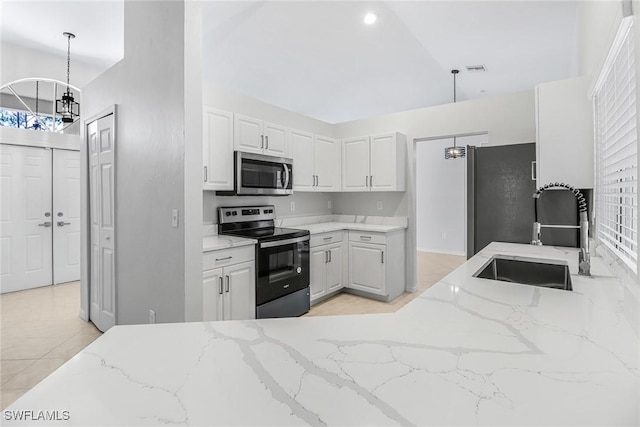 kitchen with sink, white cabinetry, hanging light fixtures, stainless steel appliances, and light stone countertops